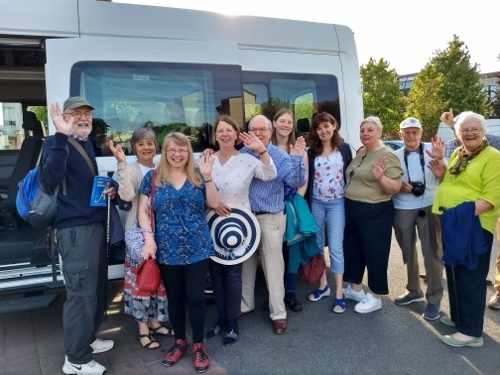 Twinning members posing by the minibus